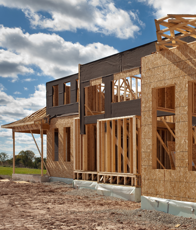 Home being built with blue skies behind it.