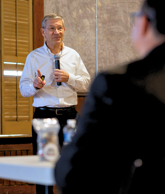 CSB President Eddie speaking during a presentation at an event.