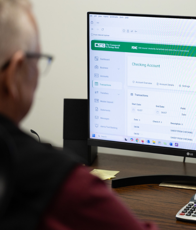 Person viewing CSB online banking dashboard on desktop monitor