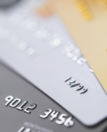 Close-up of several stacked credit cards in different colors.