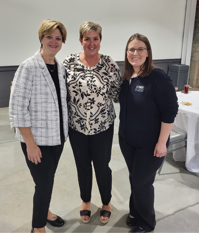 CSB employees Ami, Robyn, and Stacy smiling together at an event